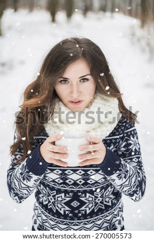 Girl with Cup of tea in the winter forest