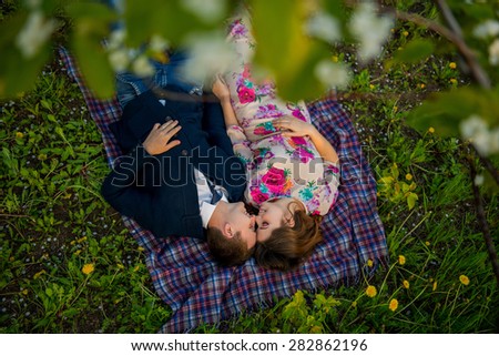 couple in love in a blooming Apple orchard lying on the blanket