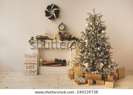 Beautiful holiday decorated room with Christmas tree with present boxes under it
