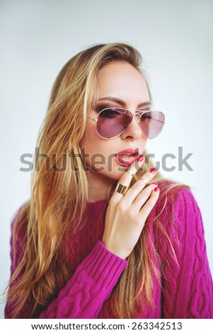 Young beautiful blonde woman portrait in pink white isolated background