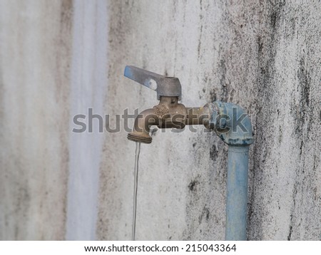 old rusty tap leaking water