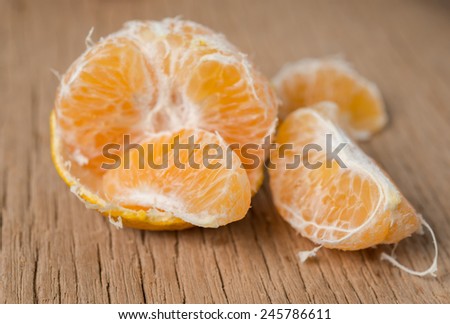 Close-up of orange fruit on old wooden board