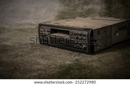 A very old car radio receiver with grunge background