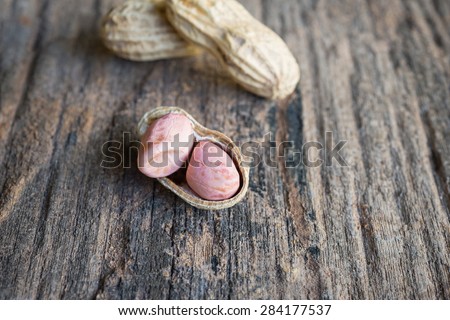 peanuts in shells on wood background