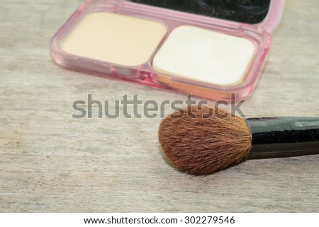 brushes,powder, puff on wood table