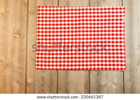 Tablecloth white red squares on wooden background