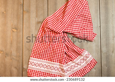 Wooden background with red squares towel