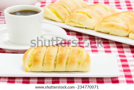 Coffee with gluten-free vanilla pastry on tablecloth white red squares
