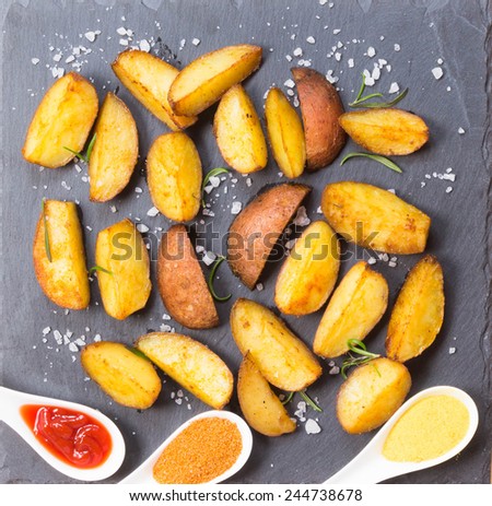 potato wedges with species on slate serving plate