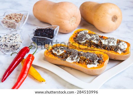 Stuffed Pumpkin with rice, onion, cheese and chia seeds on marble table