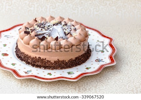 Three chocolate (dark, milk and white) cake on Christmas plate