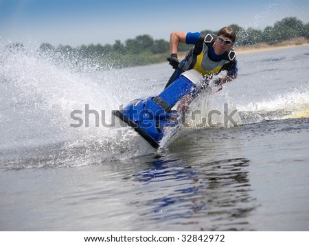 Man on jet ski in the river skims along camera