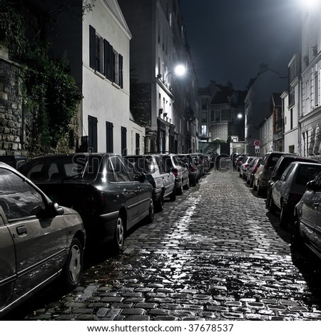 stock photo Small night street with car parking on Montmartre Paris