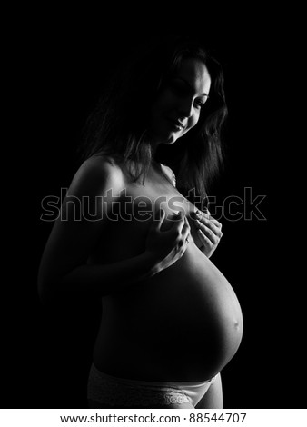 beautiful happy pregnant on the dark background