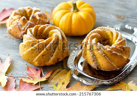Pumpkin cakes on wooden background