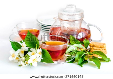 selective focus, two cups filled with tea, teapot and jusmine flower