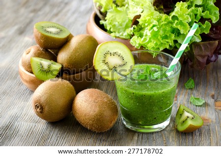 Green healthy kiwi tropical smoothie with ingredients