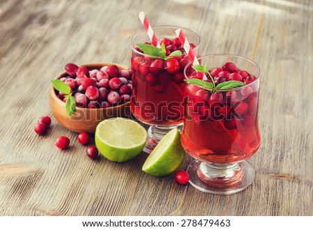 Refreshing cranberry juice drink with lime and mint, selective focus, vintage