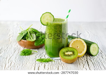 Fresh green detox smoothie on white wooden background, diet and health concept, vitamins