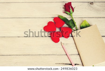 story love,Hearts, roses, pencil and book on wood
