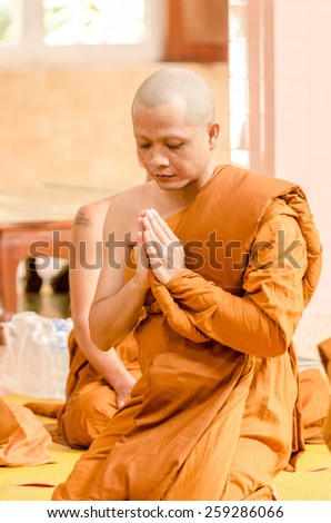 SAKONNAKHON,THAILAND December 23: Newly ordained Buddhist monk pray with priest procession. Newly ordained Buddhist monks have a ritual in the temple procession in December 23, 2012