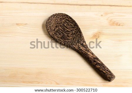 Serving spoons on wooden surface