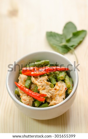 Spicy stir fried pork with red curry paste and Yard Long bean, Thai food menu
