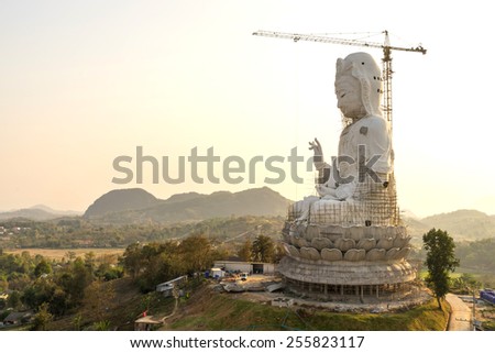 The Goddess of Compassion and Mercy (Guan Yim goddess) constructed giant statue in Thai temple under twilight sky
