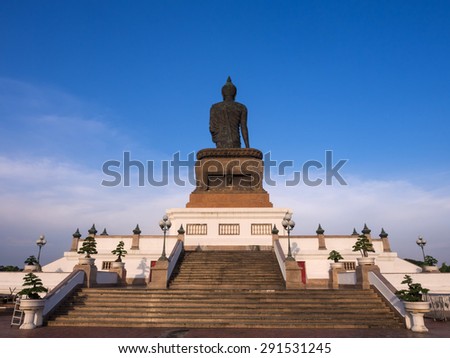 Grand walking buddha bronze statue is the major statue in Phutthamonthon (Buddhist province) in Nakornpathom, Thailand, in twilight time