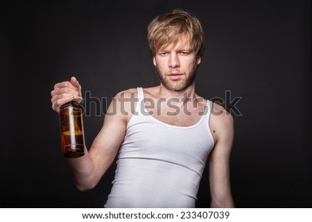 Concept: alcohol addiction. Hangover. After party. Studio portrait over black background