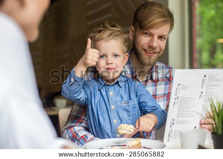 Father and son together in cafe. Family. Father\'s Day. Indoor portrait