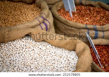 Detail from a street market scene in Tunisia, North Africa, with hessian sacks filled with dried beans and pulses.