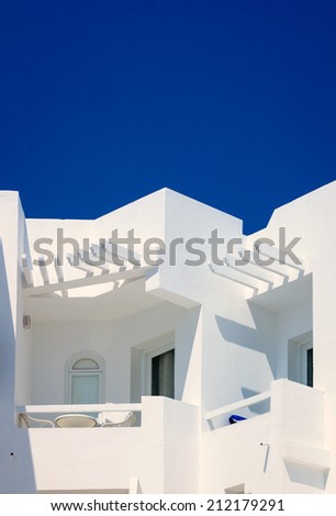 Detail of a bright white contemporary hotel complex in Tunis, Tunisia, with a cloudless blue sky providing copy space.