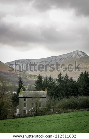 A large farm house nestling in a Welsh valley deep in the Brecon Beacons national park district.