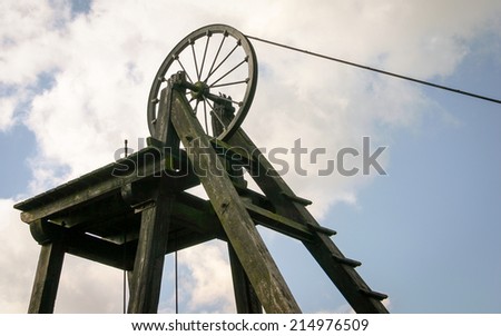An old Victorian mining wheel at the head of a now disused coal mine in Wales, UK.