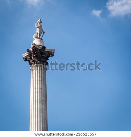 Low angle view of the London landmark Nelson\'s Column set against blue sky copy space.