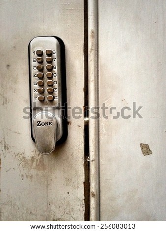 LONDON, UK - 18 SEPTEMBER 2012: A \'Zone\' combination lock on a well-used door.