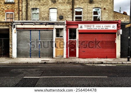 LONDON, UK - 16 SEPTEMBER 2012: Closed businesses.  The closed and shuttered shop front facades in a deprived area of North London.