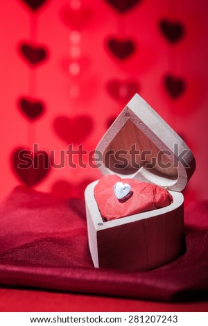 A romantic valentine still life theme gift of a diamond heart in a wooden heart shaped box.