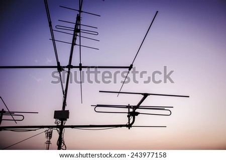 Archaic outdoor antennas silhouette at sunset