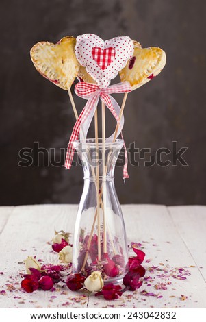 Cookies pops in the form of heart and heart from fabric with buds of roses