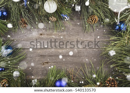 Fir-tree and Christmas jewelry on a wooden background. Copy space. Food background. Toning