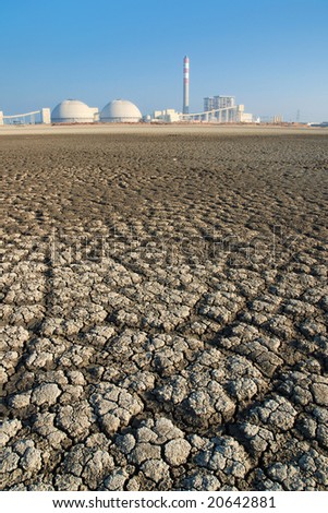 Cracks of dried Seabed backgrounded by a power Plant