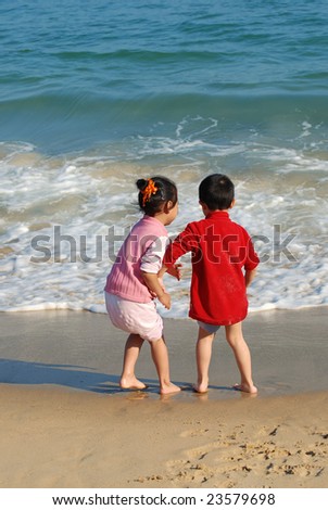 Children playing in the surfy beach,more choices available in the series