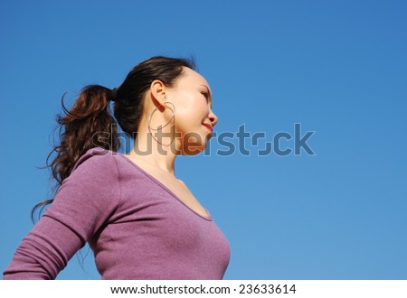 Silhouette of an energetic asian woman on blue sky background,more shots available in the same series...
