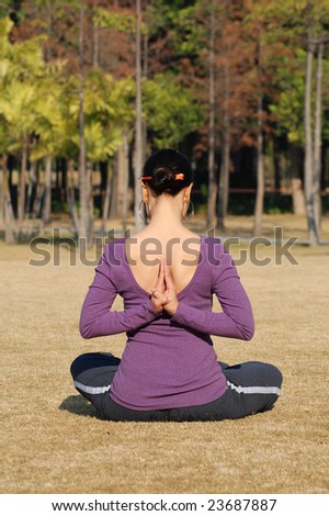 Young Asian Woman exercising Yoga in the park, more shots available in the same series...
