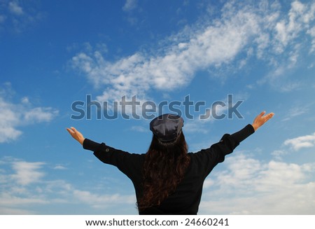 Young Woman Praying by stretching her arms towards the Sky, more shots available in the same series...