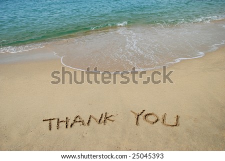 Thank You written in a sandy beach