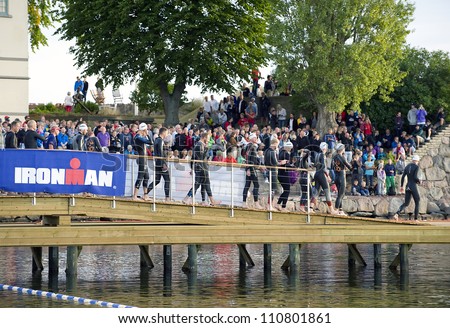 KALMAR, SWEDEN - AUGUST 18: Competitors in ironman on their way to the start on August 18, 2012 in Kalmar.