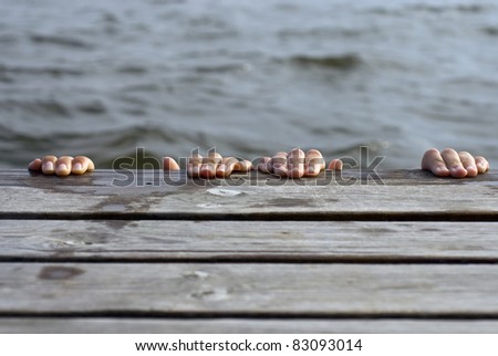 Young people playing on the swim platform, both hiding from the photographer